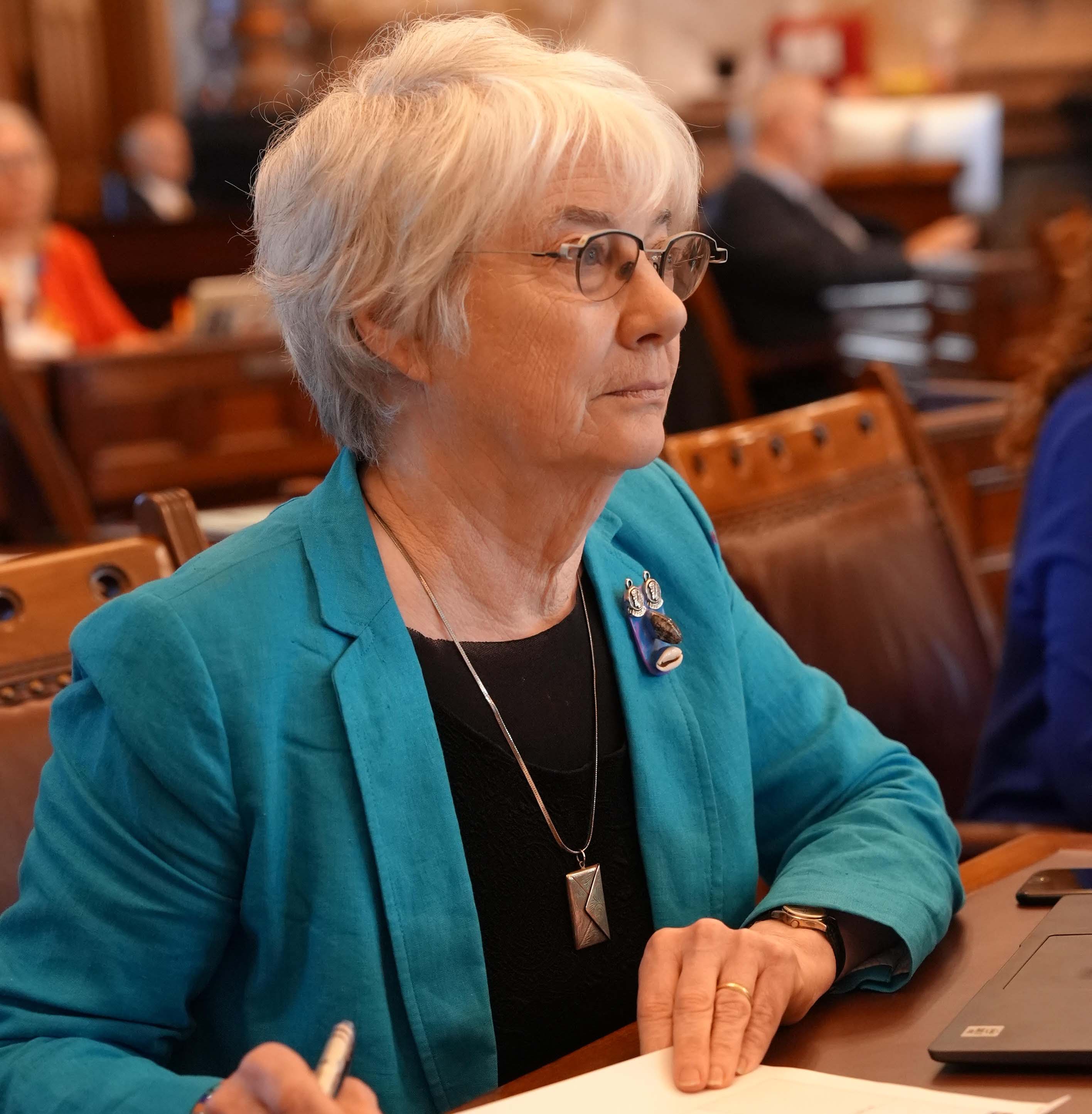 Marci in the Senate wearing a teal jacket